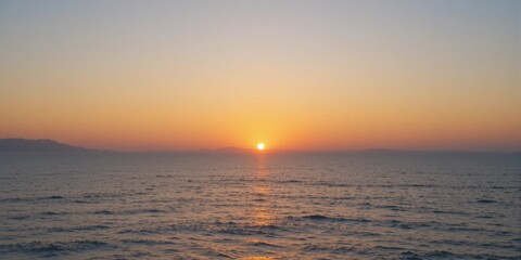 Sunset over snowy river and sea with orange sky and reflections on water