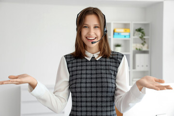Portrait of female technical support agent in headset talking at office