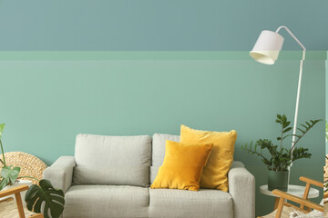 Interior of stylish living room with grey sofa, armchairs and standard lamp