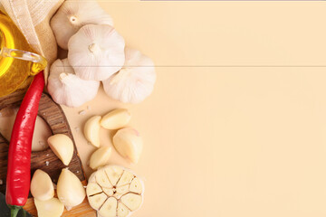 Fresh garlics and chili pepper on beige background