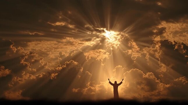 Silhouette of a person with arms outstretched against a cloudy sky at sunset or sunrise