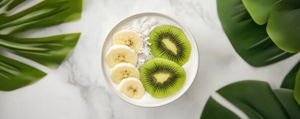 Healthy fruit breakfast bowl with banana and kiwi slices over yogurt