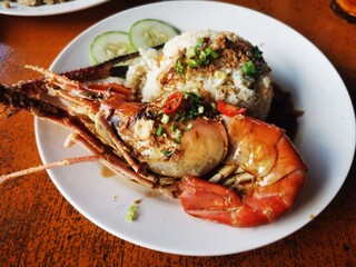 Delicious Grilled Giant River Prawn with Fried Rice Garnished with Herbs and Spices