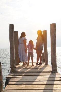 Mother and daughters enjoying the view of Lake Atitlan, Panajachel, Solola, Guatemala 
