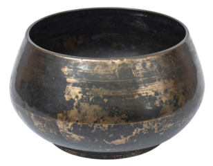 Ancient weathered brass Tibetan singing bowl offering serene meditation and spiritual resonance.