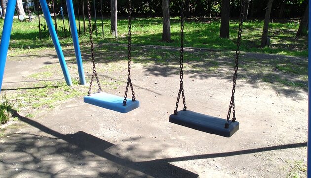 Empty playground swings on a sunny day