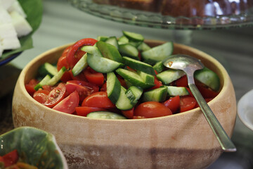 Fresh vegetable salad with cucumbers and tomatoes in a bowl