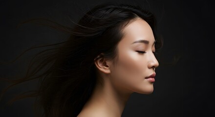 Fototapeta premium Elegant Asian Woman with Flowing Hair, Closed Eyes, Serene Expression, Beauty Portrait