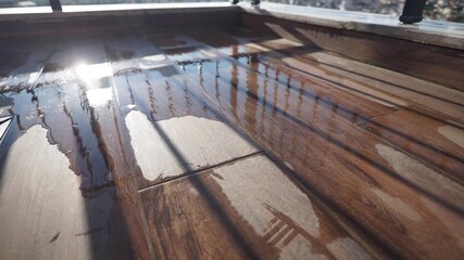 Water pooling under balcony railing at sunset - Powered by Adobe