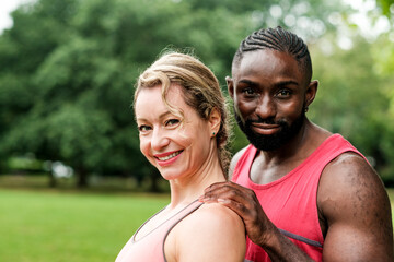 Fototapeta premium Personal trainer supporting client during outdoor workout session