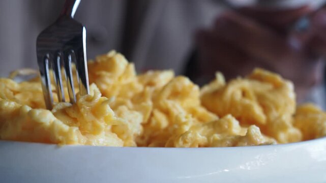 Scrambling eggs at a cozy breakfast spot in the morning