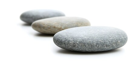 Close-up of three smooth pebbles in a row on white background, captured with 50mm lens, focus on polished surfaces and subtle shadow gradients in simple layout