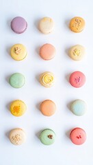 Obraz premium Assortment of colorful macarons arranged in rows on white