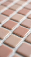Fototapeta premium Close up of small square mosaic tiles in soft pink and beige tones