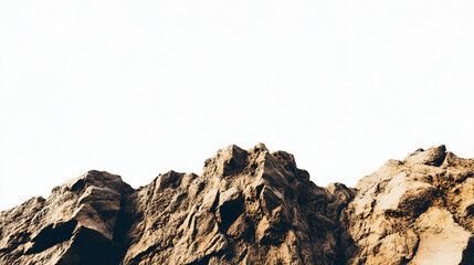 A low angle view of a rugged, brown mountain range with jagged peaks against a stark white sky.