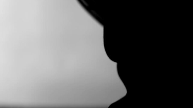 Silhouette of a man in deep thought. Black and white.