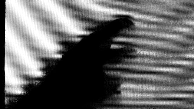 Silhouette of a man knocking at glass door