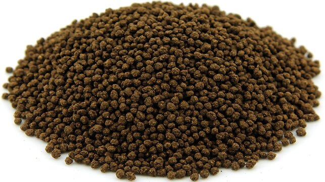 Sandy soil sample with small pebbles on white background taken with zoom lens 135mm, sharp focus on gritty texture and natural particle size variation