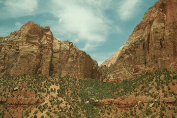giant red rock cliffs and greenery and blue skies near zion and bryce national parks utah in summer, zion canyon overlook trail