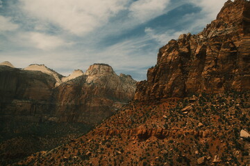giant red rock cliffs and greenery and blue skies near zion and bryce national parks utah in summer, zion canyon overlook trail