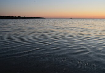 Serene Sunrise Reflection on Calm Waters