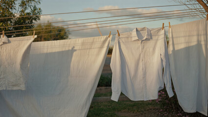 White laundry drying on an outdoor line.