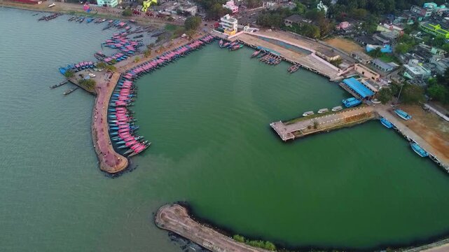 lots of boats berthing in chilika lake harbour cinematic aerial drone view 