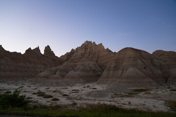 Sharp peaks and rounded hills in Badlands during dusk