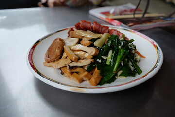 A plate of food with meat, vegetables, and tofu