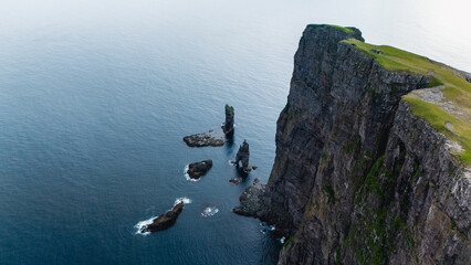 Majestic cliffs and serene waters of the Faroe Islands capture natures grandeur © Fokke Baarssen