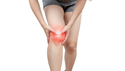Young athletic woman holding painful knee showing discomfort isolated on white background