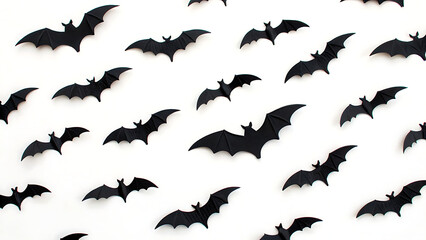 Obraz premium Numerous silhouetted black bats flying across a clean white background creating a spooky halloween pattern