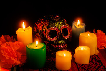 Day of the Dead altar with symbolic black skull, flower petals and candlelight decorations