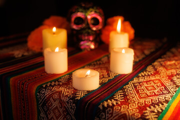 Cultural Day of the Dead altar with black skull, floral metal accents, magnolias and multicolor candles