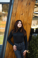 Girl on the street near the mirror window