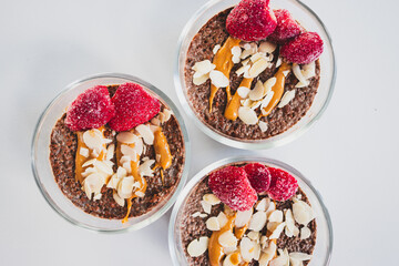 cocoa chia pudding with almond flakes peanut butter and frozen strawberries