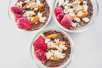 cocoa chia pudding with almond flakes peanut butter and frozen strawberries