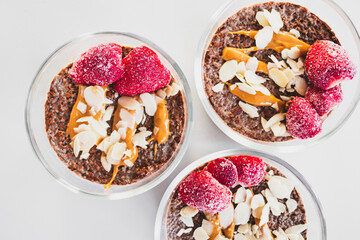cocoa chia pudding with almond flakes peanut butter and frozen strawberries