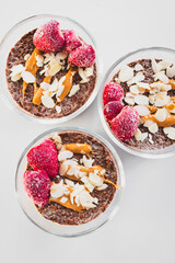 cocoa chia pudding with almond flakes peanut butter and frozen strawberries