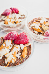cocoa chia pudding with almond flakes peanut butter and frozen strawberries