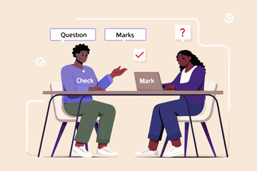 Students discussing questions and marks while checking work on a laptop