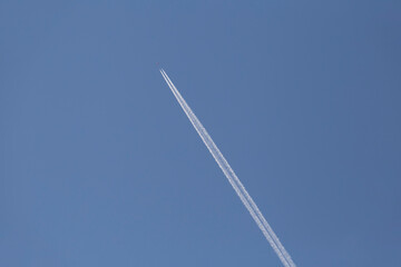 contrails from aircraft in a clear blue sky