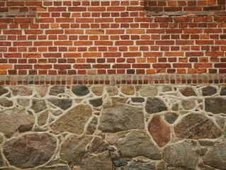 Historic base masonry made of fieldstone with bead joints and base cornice made of brick. Authentic traditional masonry from past centuries. Copyspace © Frank