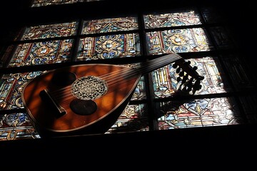 Stained glass window with lute in old church  
