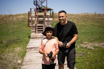 Father and son preparing drone controllers for flight