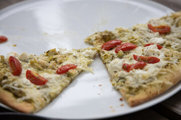 Freshly Baked Pizza Slices with Toppings on a White Plate