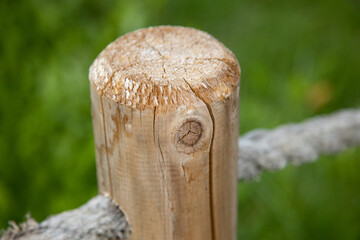Close-Up of Wooden Fence Post with Rope Detail in Nature