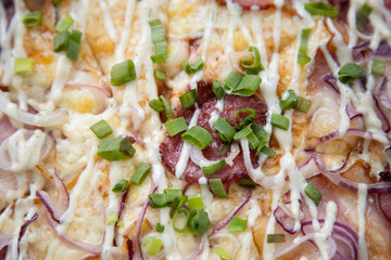 Delicious Pepperoni Pizza topped with cheese and Green onions close-up