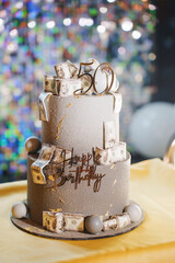 Celebration cake topped with fake money for a 50th birthday party