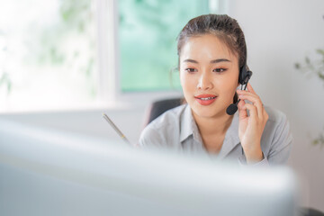 Remote Work. Focused woman in headset providing customer service in office.